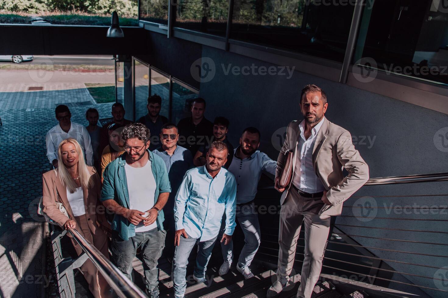 A diverse group of businessmen and colleagues walking together by their workplace, showcasing collaboration and teamwork in the company. photo