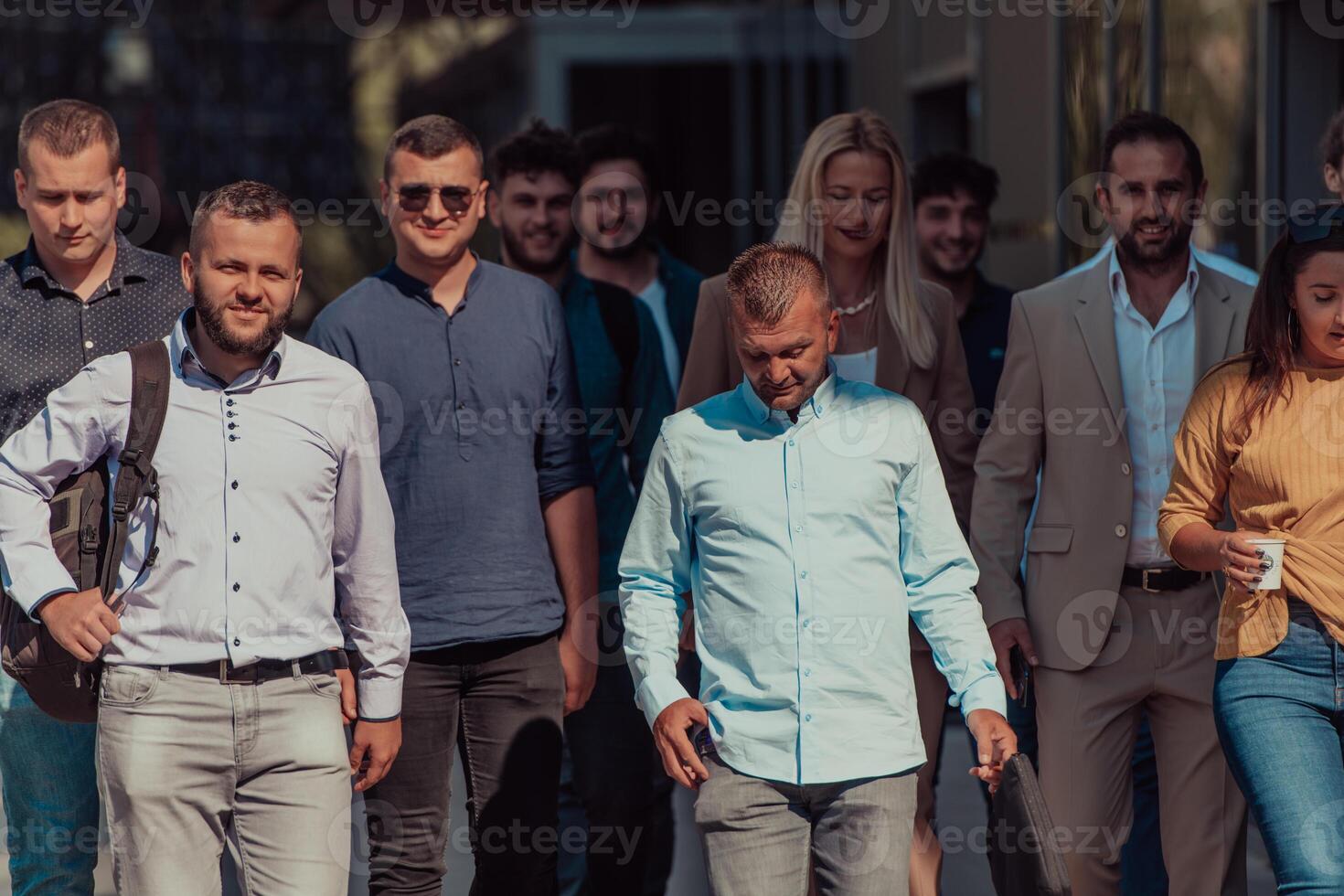A diverse group of businessmen and colleagues walking together by their workplace, showcasing collaboration and teamwork in the company. photo