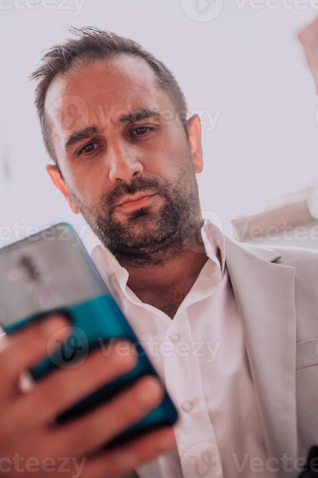 A businessman using his smartphone outdoors, showcasing the seamless integration of technology and mobility in modern professional life. photo