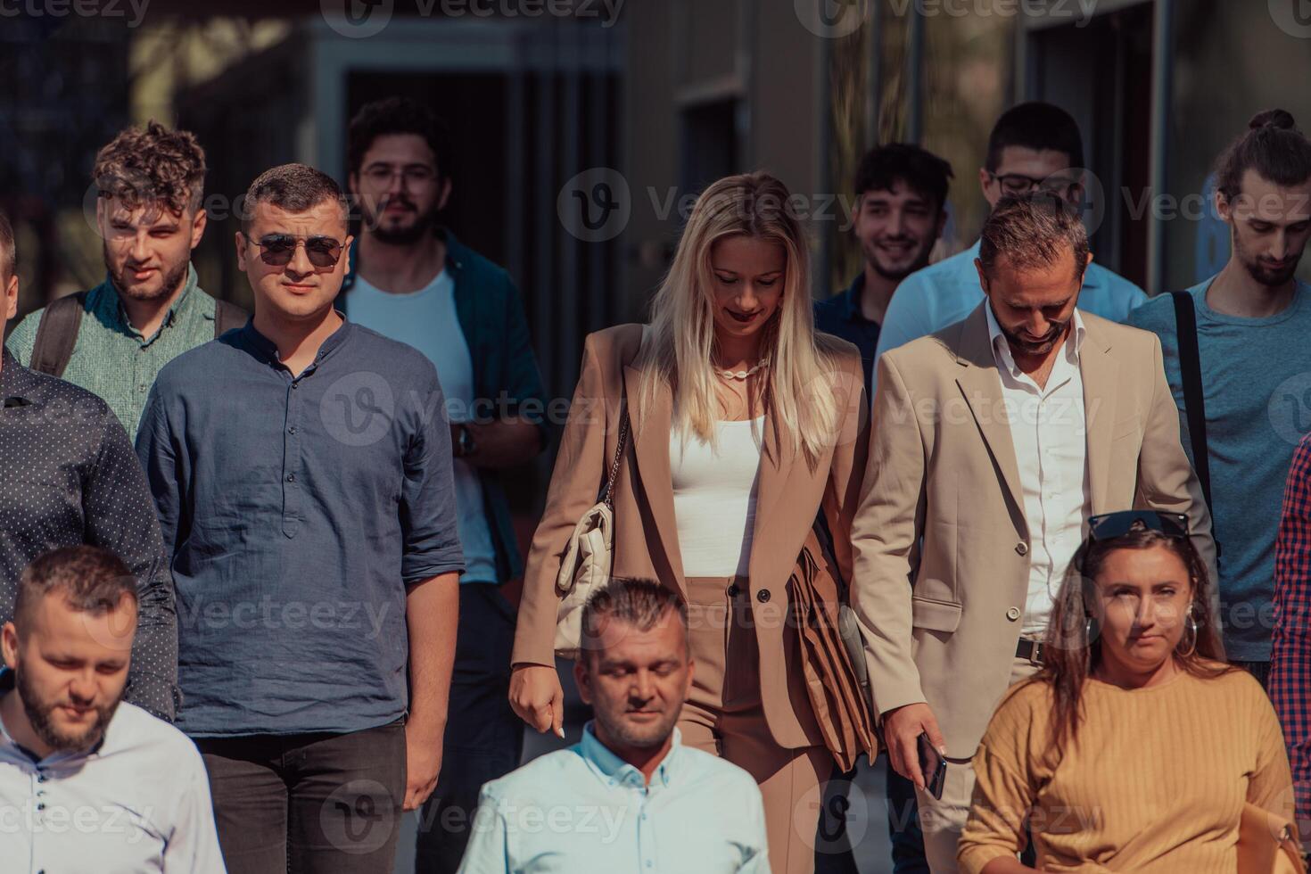 A diverse group of businessmen and colleagues walking together by their workplace, showcasing collaboration and teamwork in the company. photo