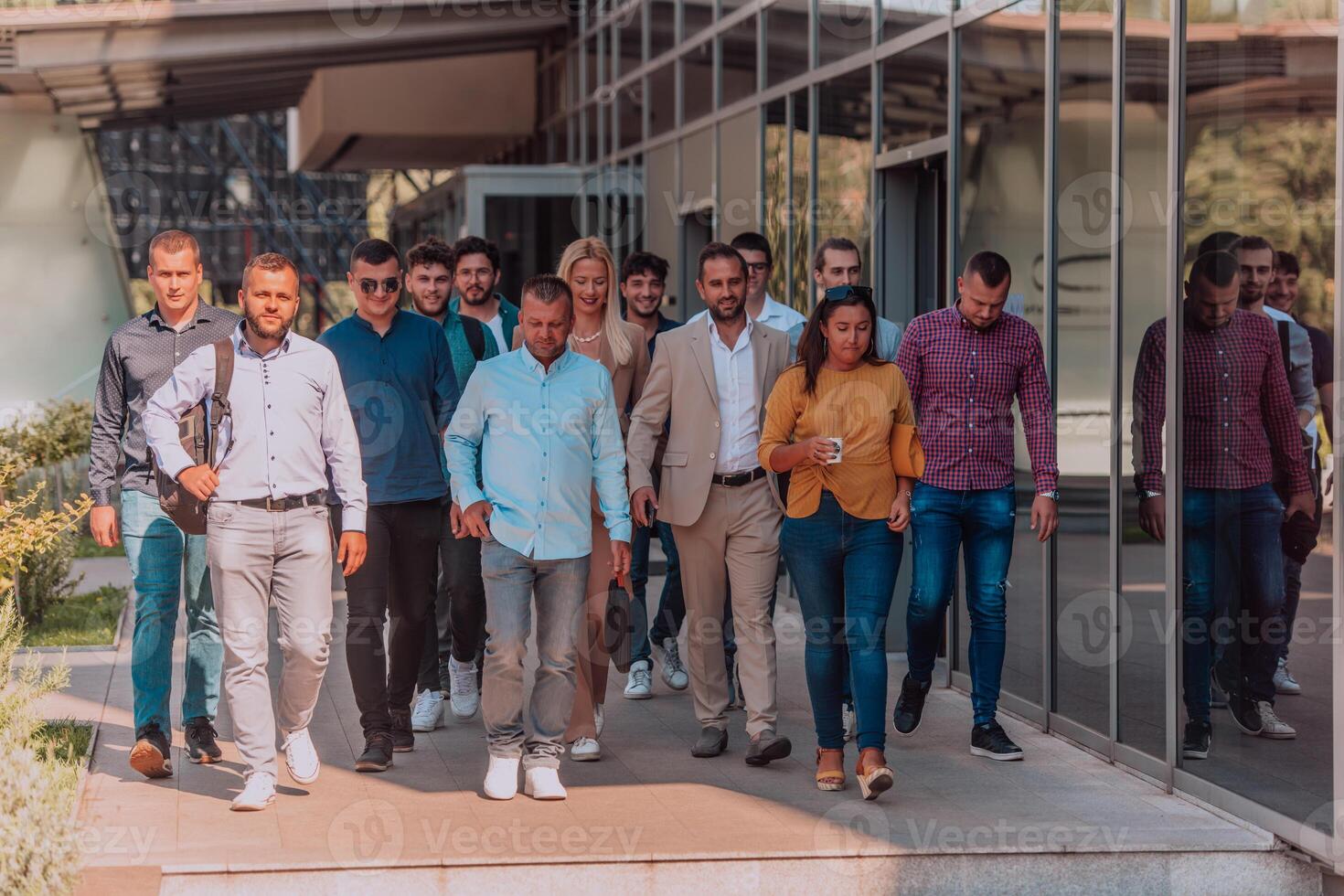 A diverse group of businessmen and colleagues walking together by their workplace, showcasing collaboration and teamwork in the company. photo