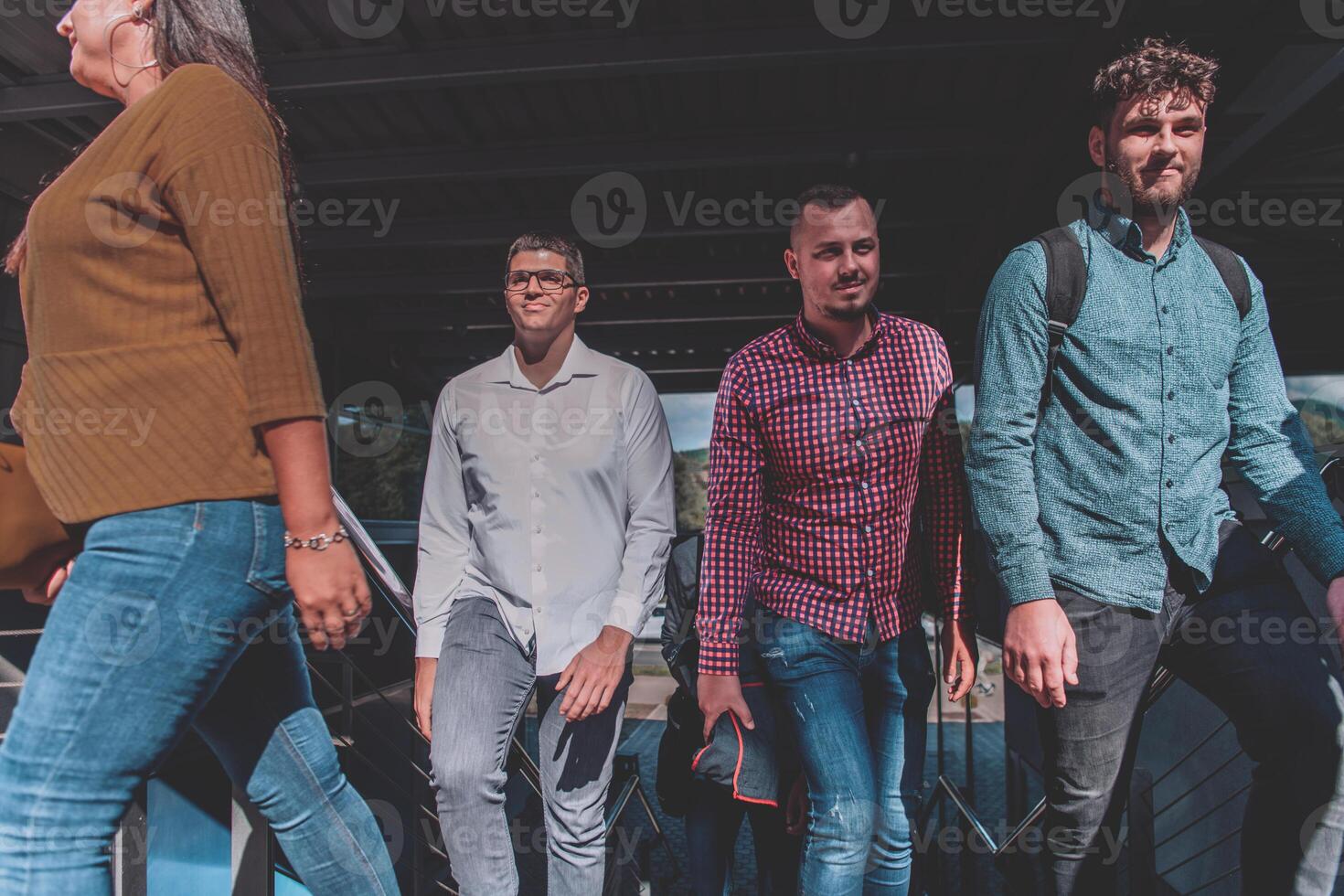 A diverse group of businessmen and colleagues walking together by their workplace, showcasing collaboration and teamwork in the company. photo