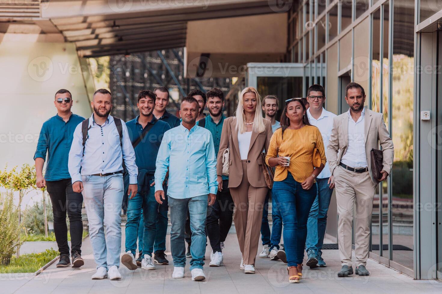 A diverse group of businessmen and colleagues walking together by their workplace, showcasing collaboration and teamwork in the company. photo