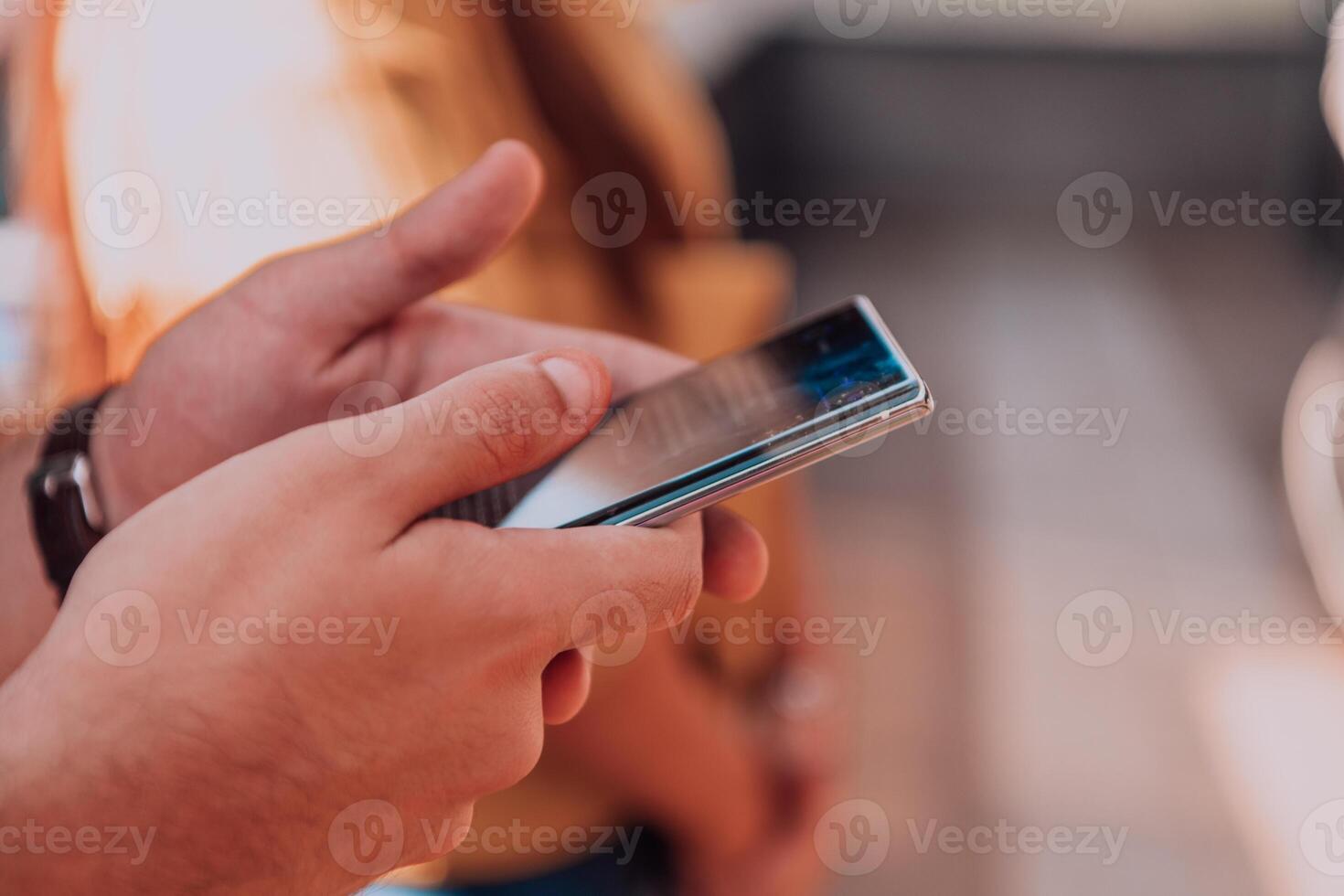 Closeup photo of businessman hand utilizes his smartphone outdoors, showcasing the seamless integration of technology and mobility in modern professional life.