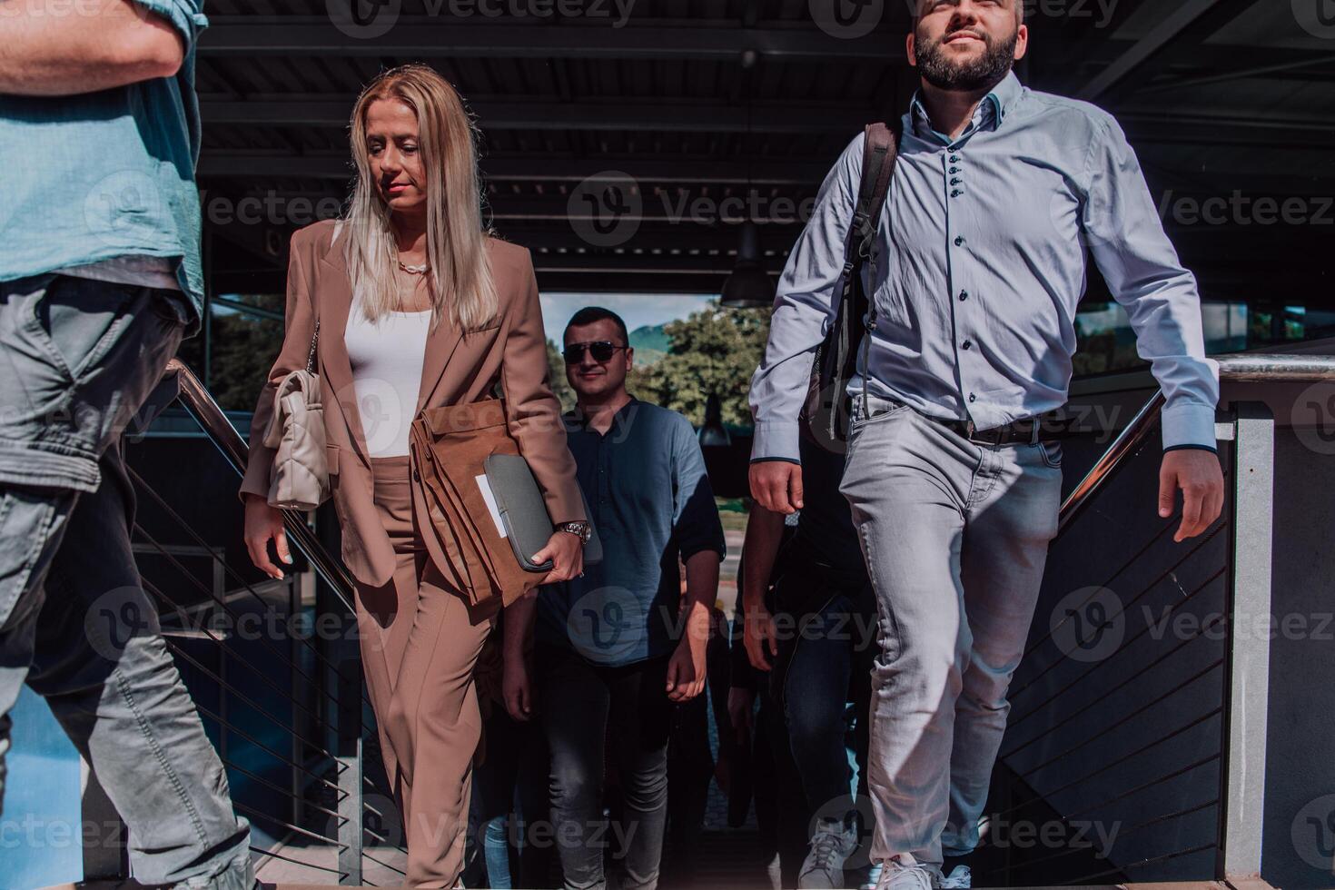 A diverse group of businessmen and colleagues walking together by their workplace, showcasing collaboration and teamwork in the company. photo