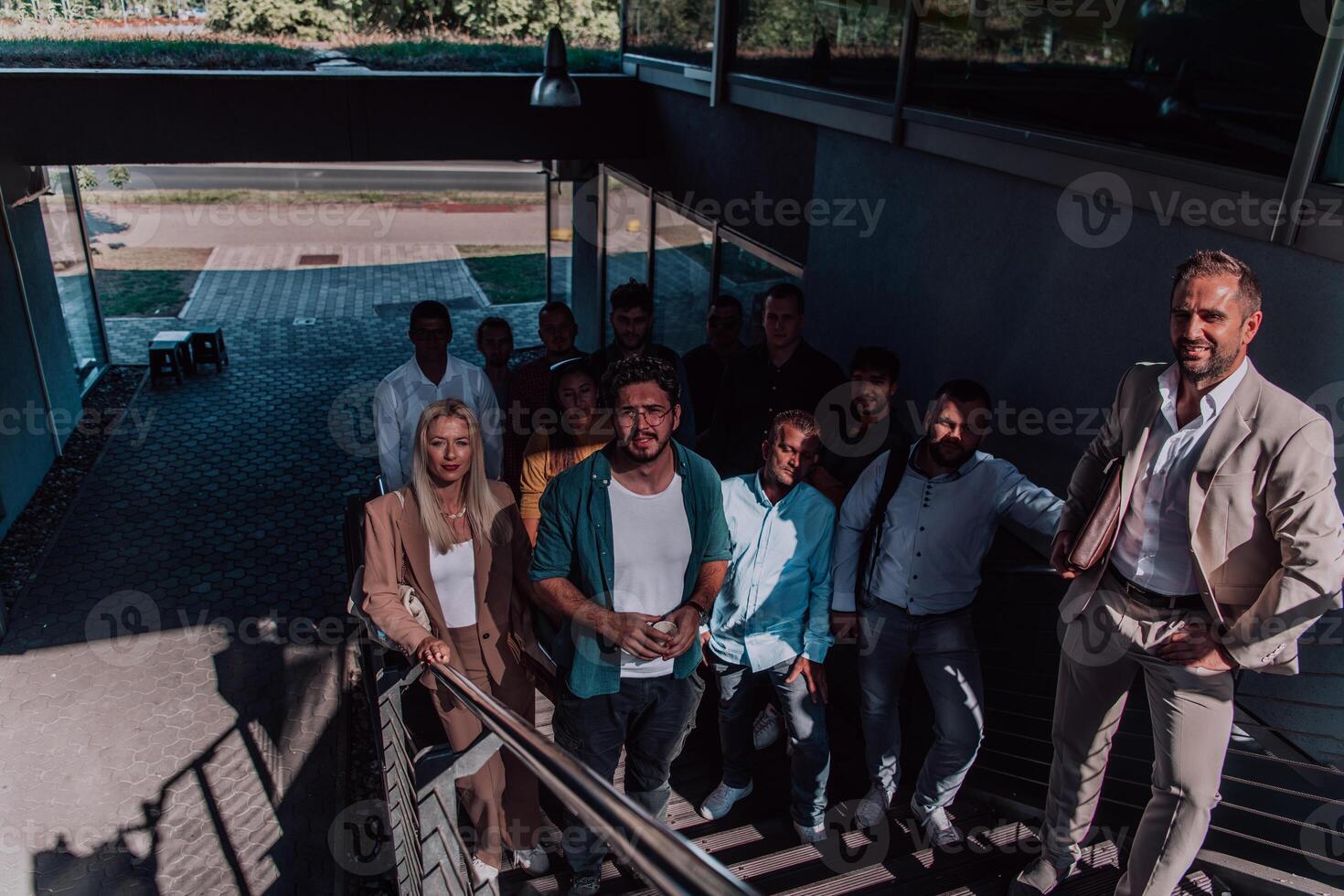A diverse group of businessmen and colleagues walking together by their workplace, showcasing collaboration and teamwork in the company. photo