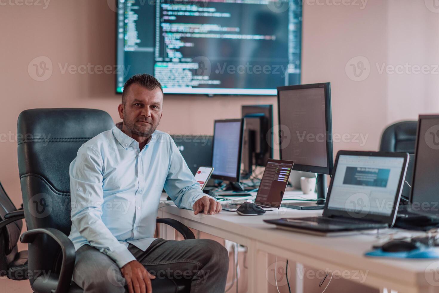 A programmer diligently testing smartphone applications while sitting in their office. photo