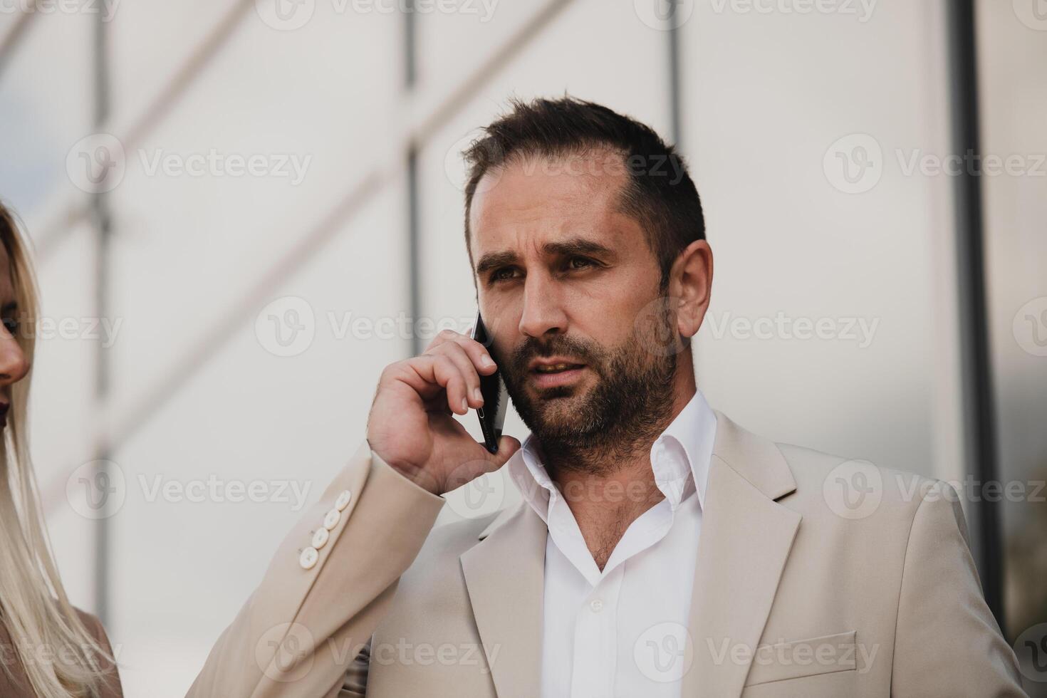 A businessman using his smartphone outdoors, showcasing the seamless integration of technology and mobility in modern professional life. photo