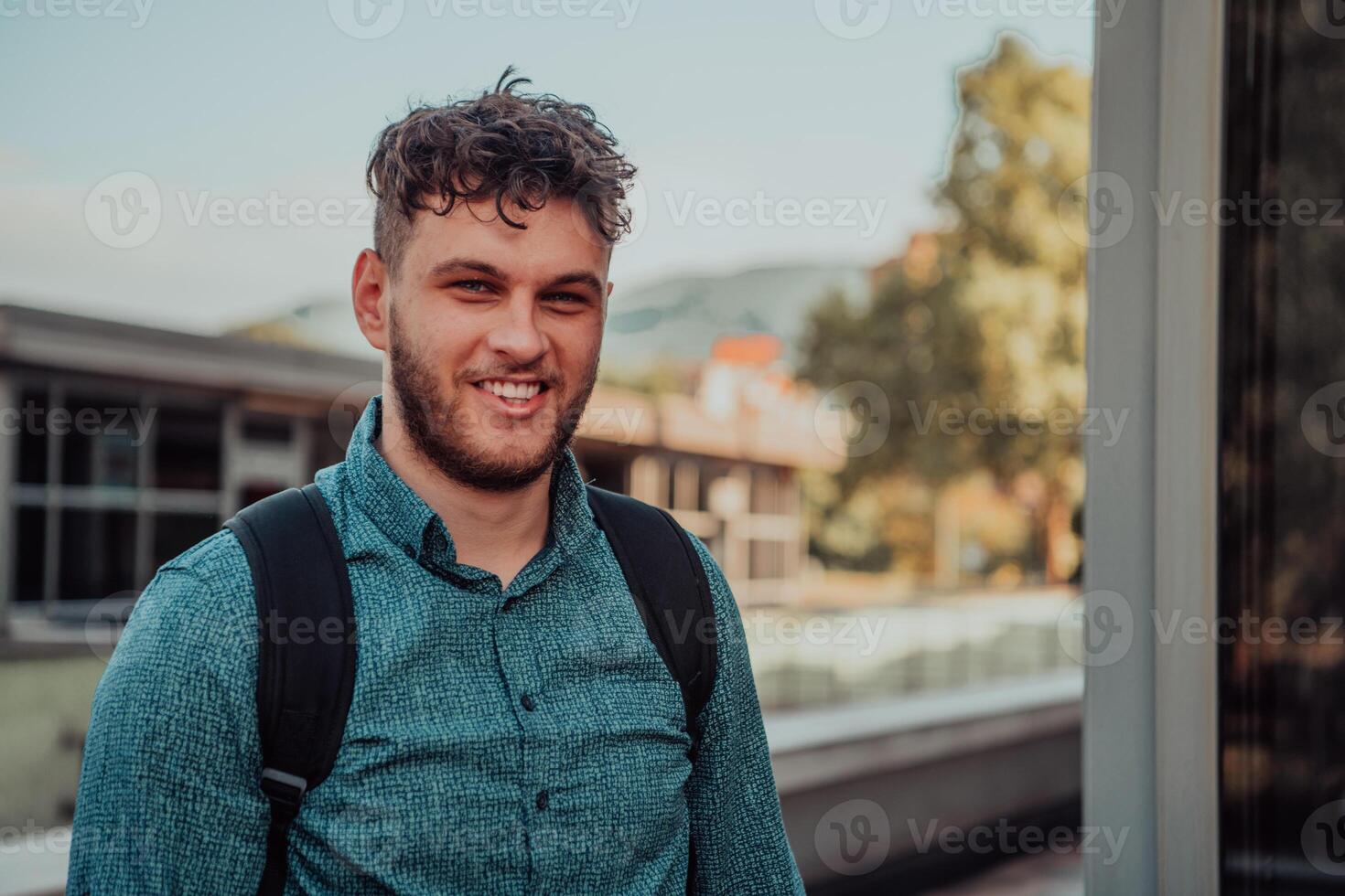 A portrait of a modern man, exuding confidence and style, against an outdoor backdrop, showcasing his charisma and fashionable demeanor. photo