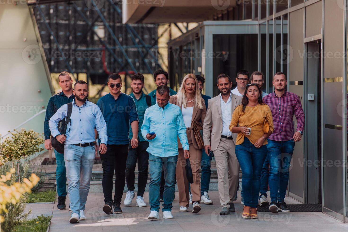 A diverse group of businessmen and colleagues walking together by their workplace, showcasing collaboration and teamwork in the company. photo