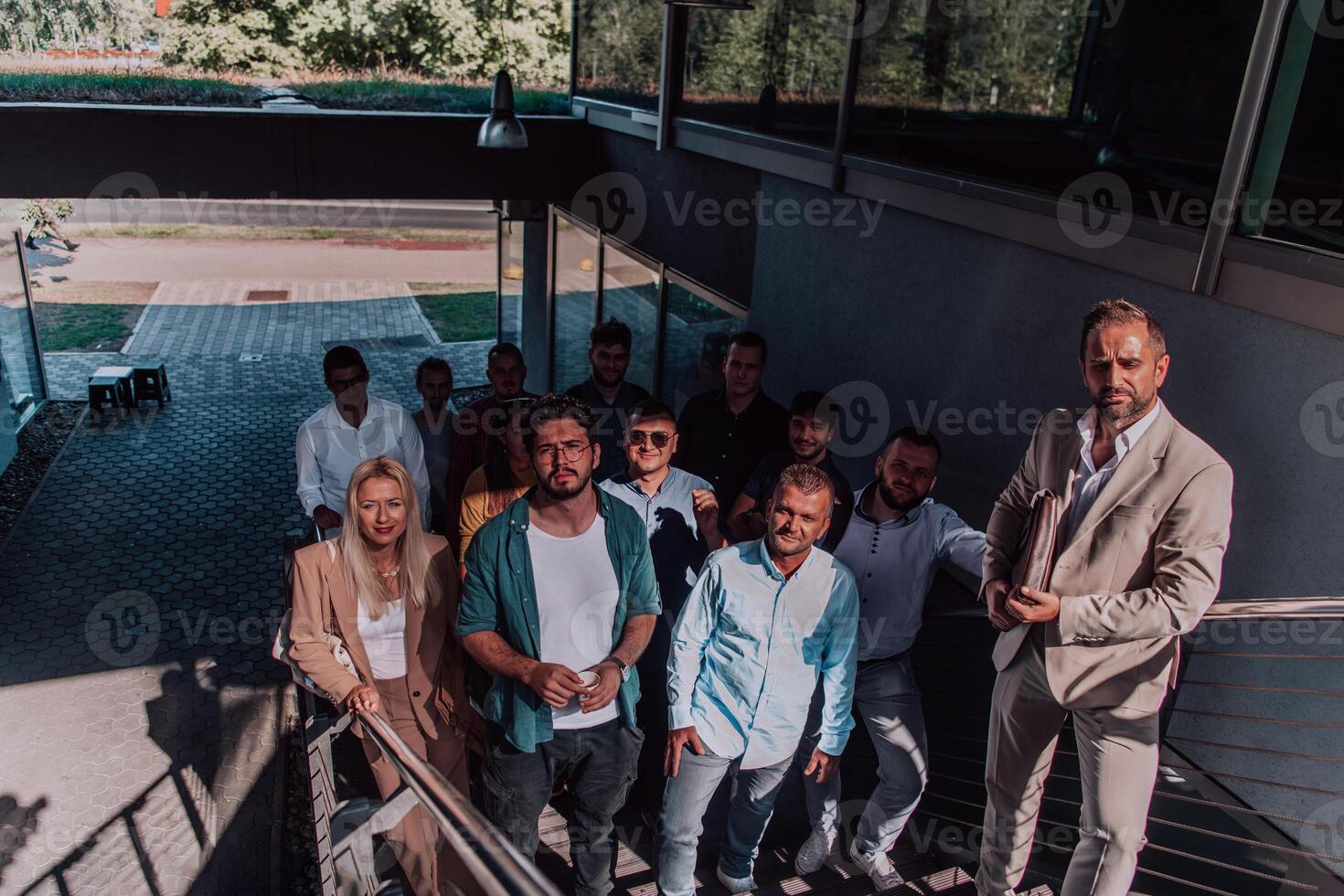 A diverse group of businessmen and colleagues walking together by their workplace, showcasing collaboration and teamwork in the company. photo