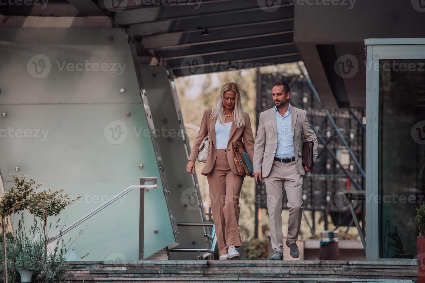 Modern business couple after a long day's work, walking together towards the comfort of their home, embodying the perfect blend of professional success and personal contentment. photo