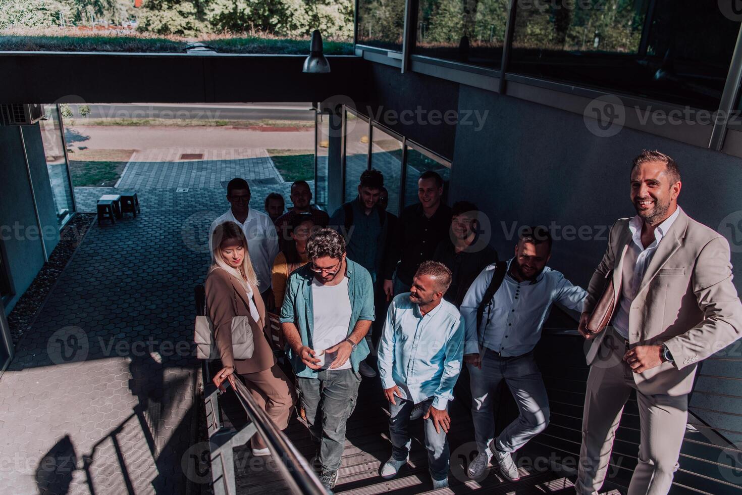 A diverse group of businessmen and colleagues walking together by their workplace, showcasing collaboration and teamwork in the company. photo