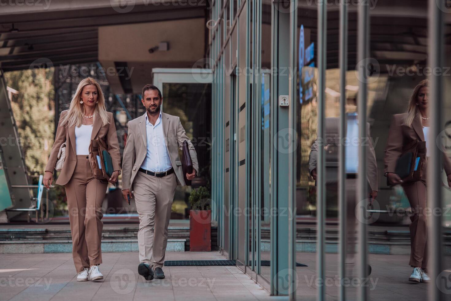 Modern business couple after a long day's work, walking together towards the comfort of their home, embodying the perfect blend of professional success and personal contentment. photo