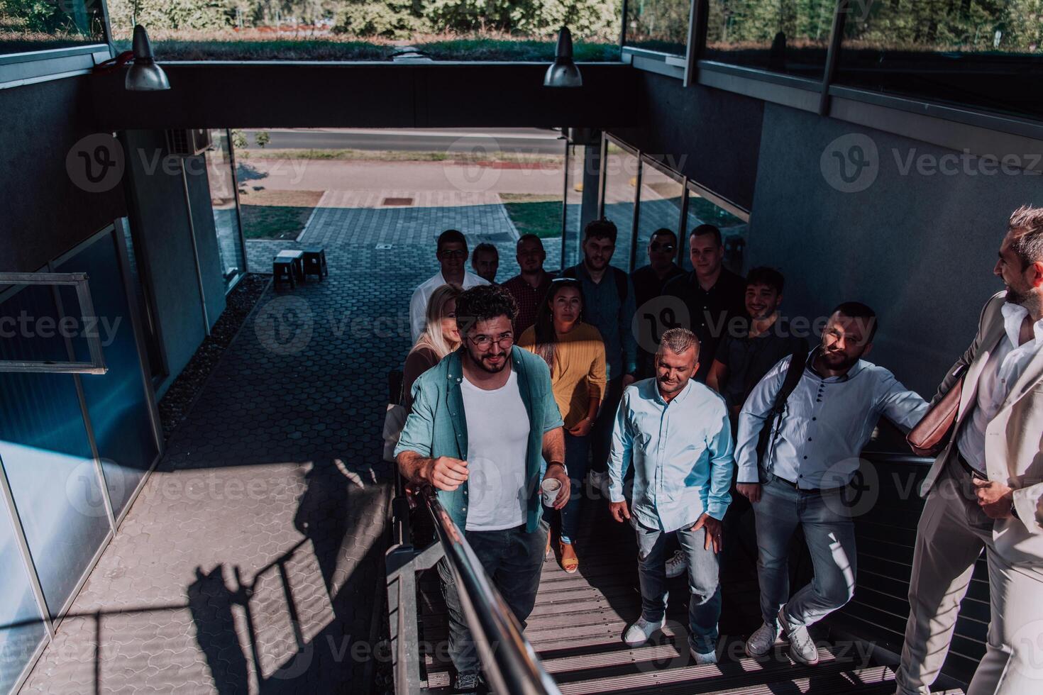 A diverse group of businessmen and colleagues walking together by their workplace, showcasing collaboration and teamwork in the company. photo