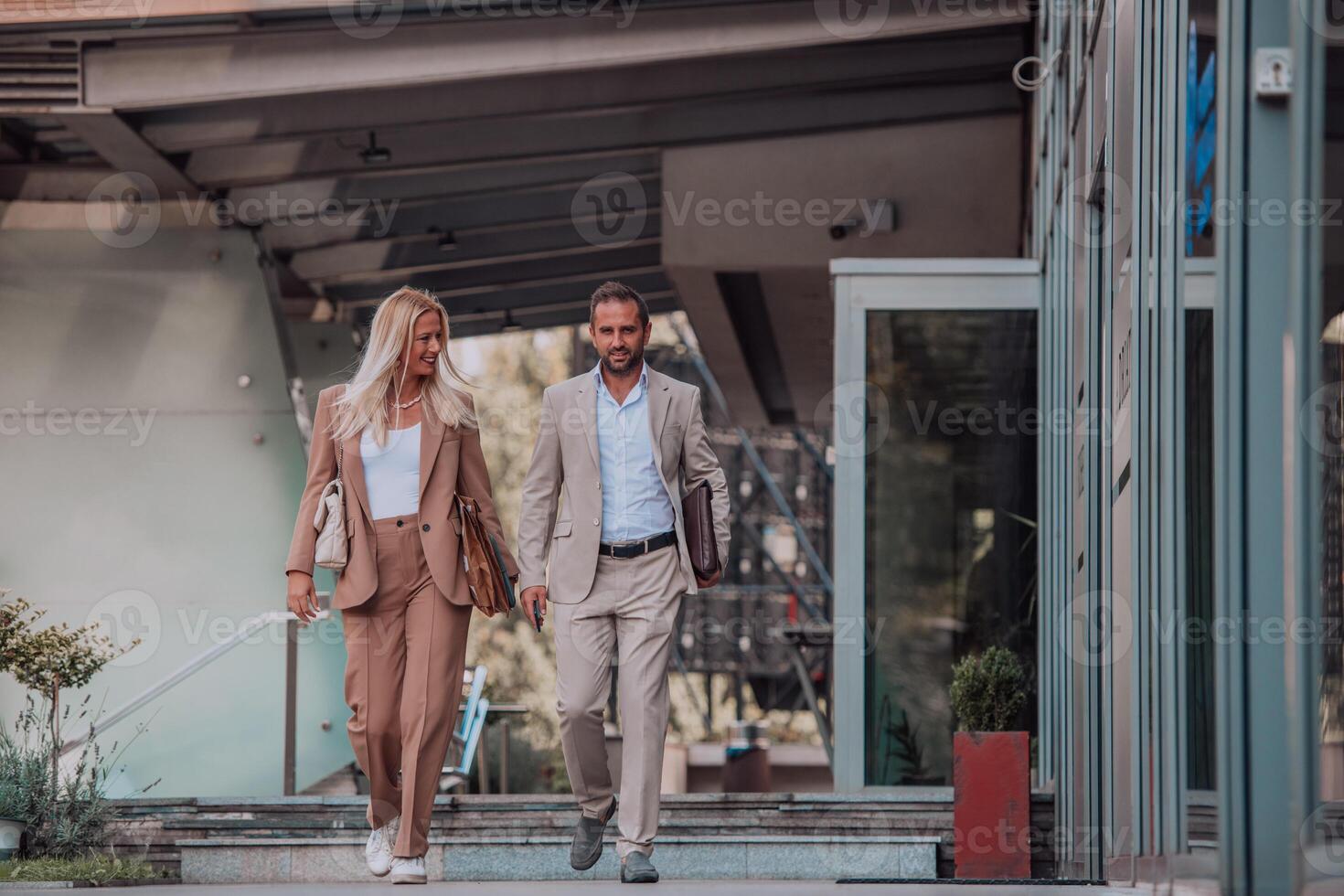 Modern business couple after a long day's work, walking together towards the comfort of their home, embodying the perfect blend of professional success and personal contentment. photo