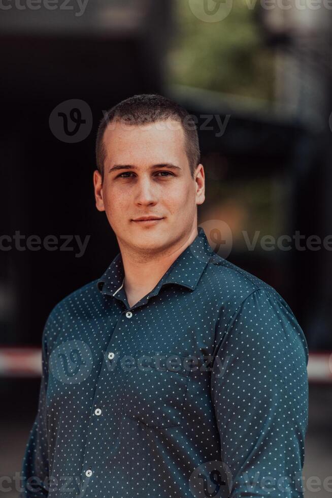 A portrait of a modern man, exuding confidence and style, against an outdoor backdrop, showcasing his charisma and fashionable demeanor. photo