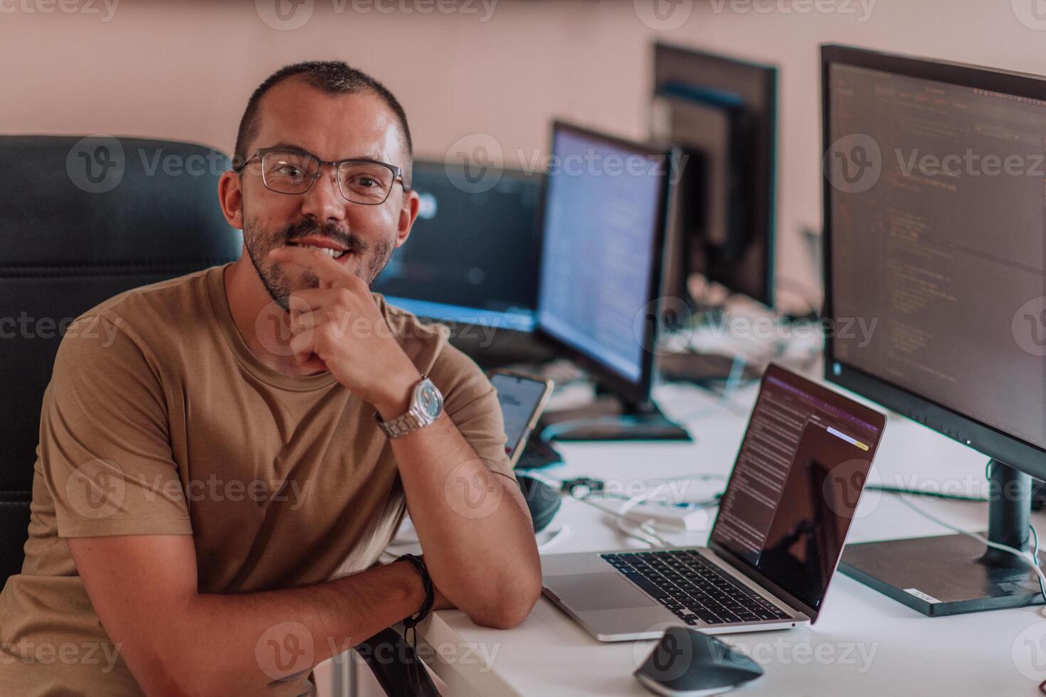 A programmer diligently testing smartphone applications while sitting in their office. photo