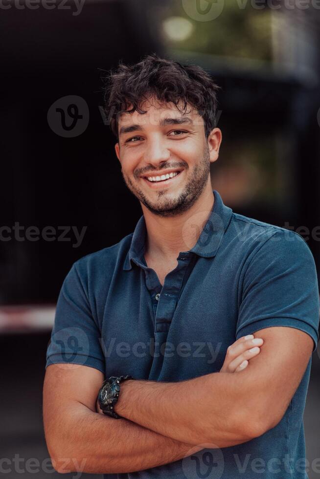 Portrait of a young successful entrepreneur in front of the company photo