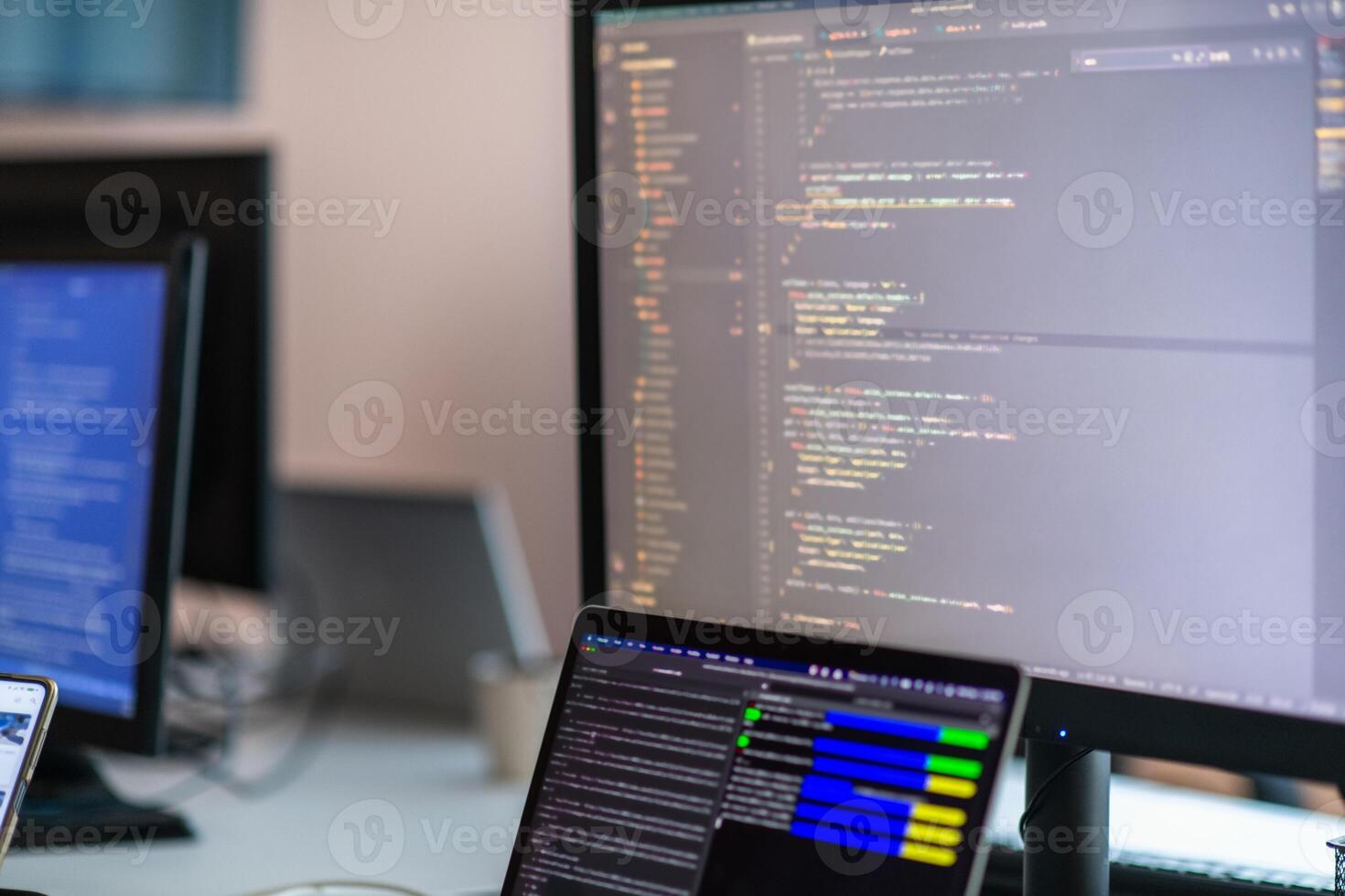 Computer screens running programming code in empty software developing agency office and computers parsing data algorithms in background. Neural network servers cloud computing in data room. photo