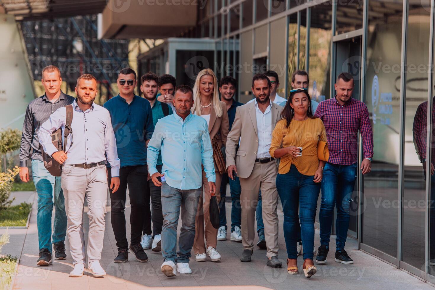A diverse group of businessmen and colleagues walking together by their workplace, showcasing collaboration and teamwork in the company. photo