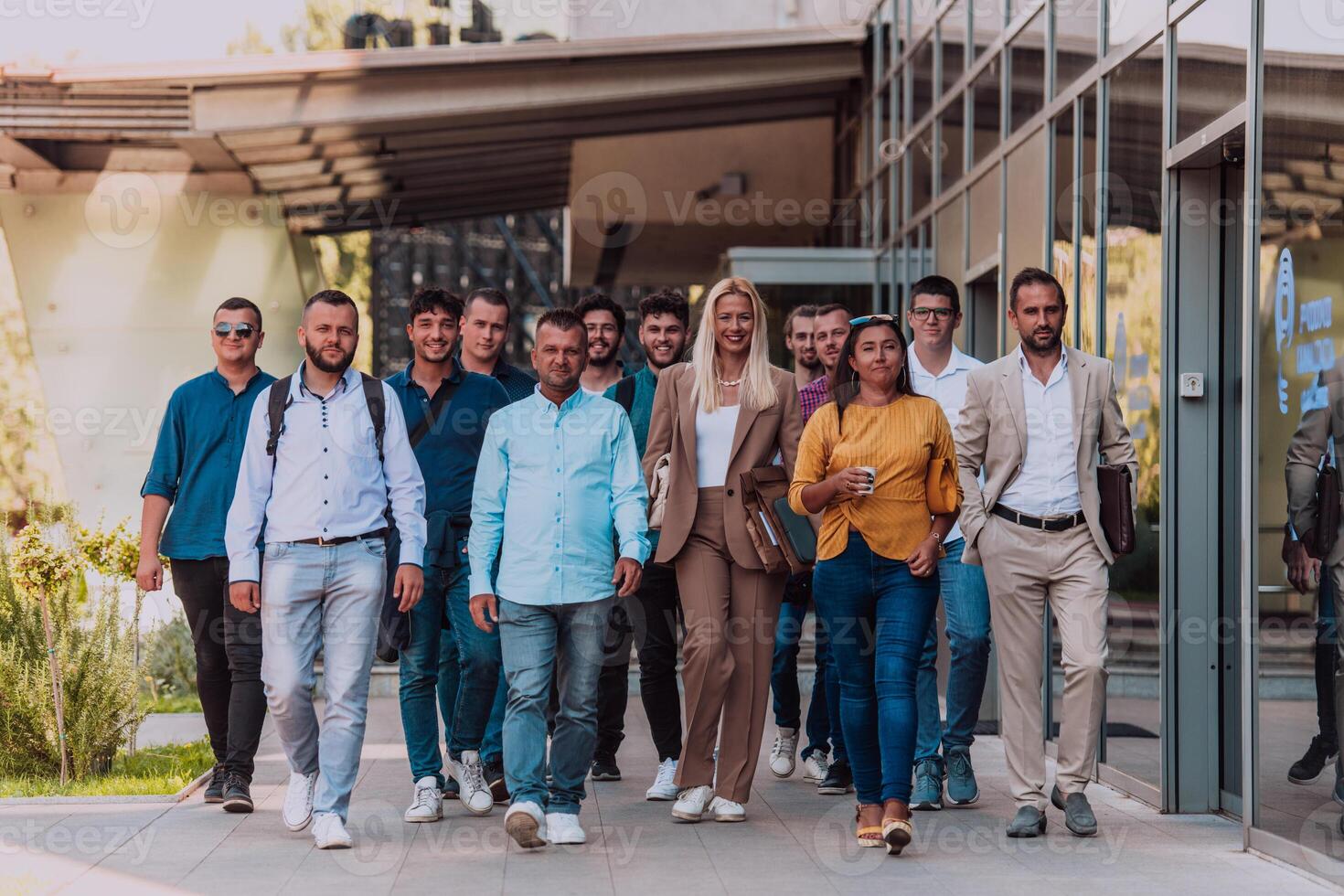 A diverse group of businessmen and colleagues walking together by their workplace, showcasing collaboration and teamwork in the company. photo