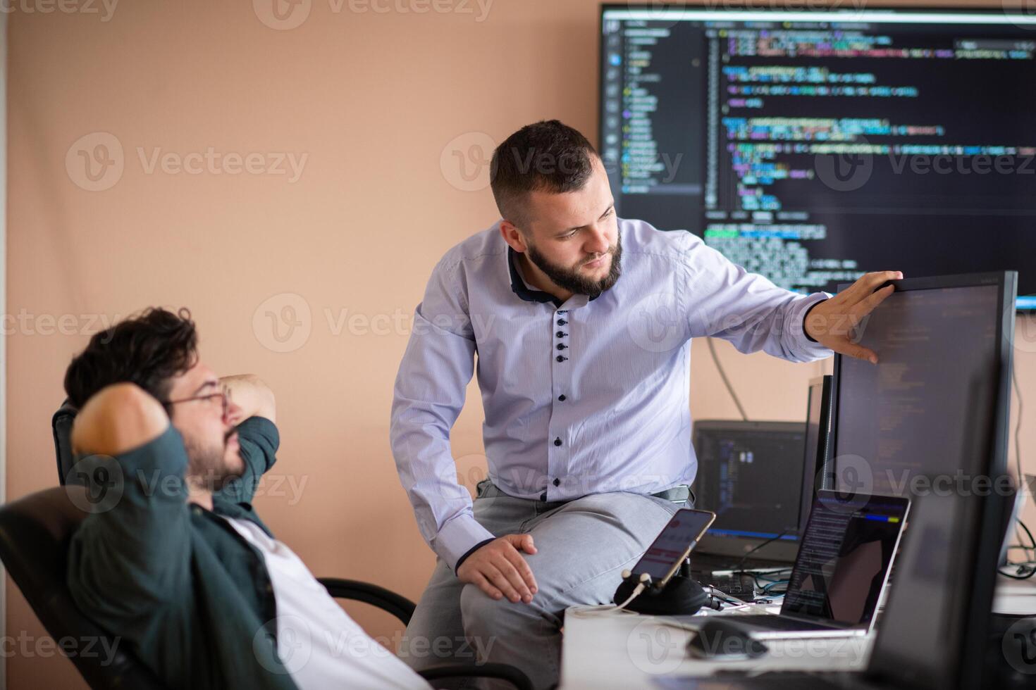 Programmers engrossed in deep collaboration, diligently working together to solve complex problems photo