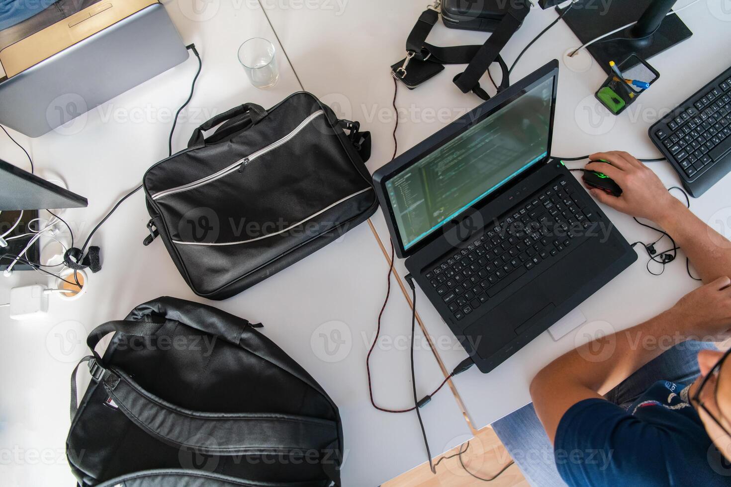 Top view of programmer diligently testing smartphone applications while sitting in their office. photo