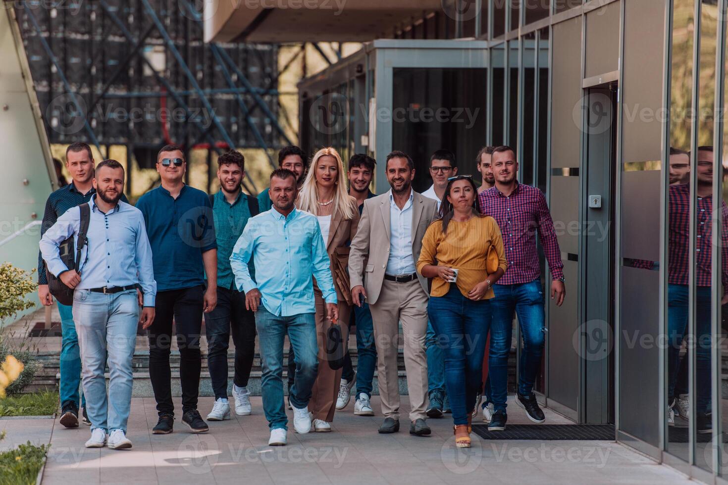 A diverse group of businessmen and colleagues walking together by their workplace, showcasing collaboration and teamwork in the company. photo