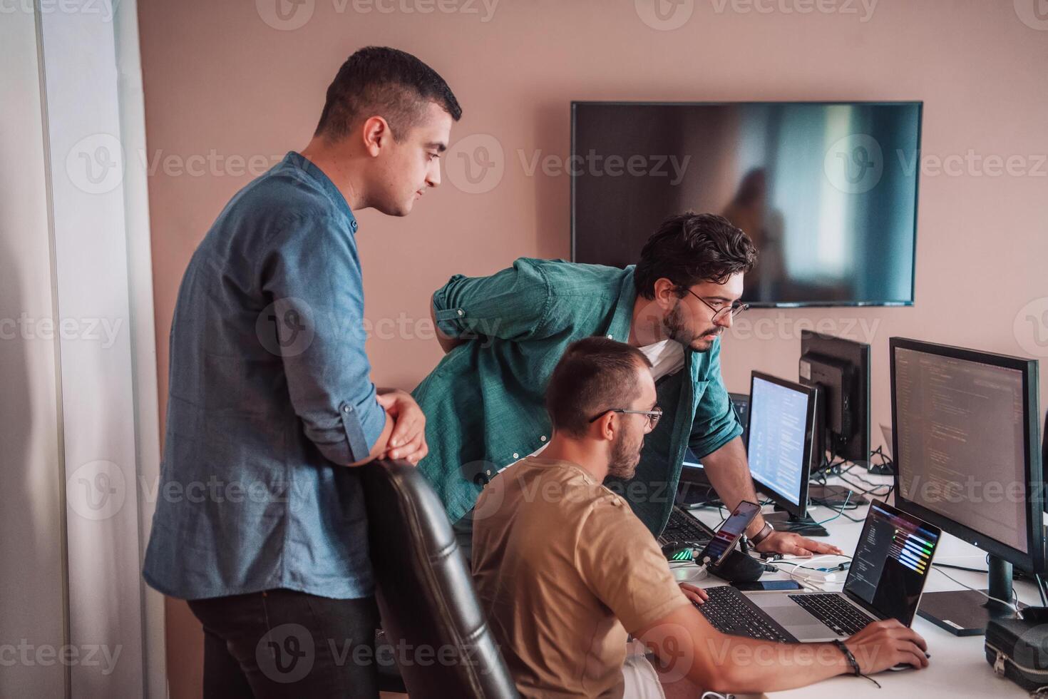 Programmers engrossed in deep collaboration, diligently working together to solve complex problems and develop innovative mobile applications with seamless functionality. photo