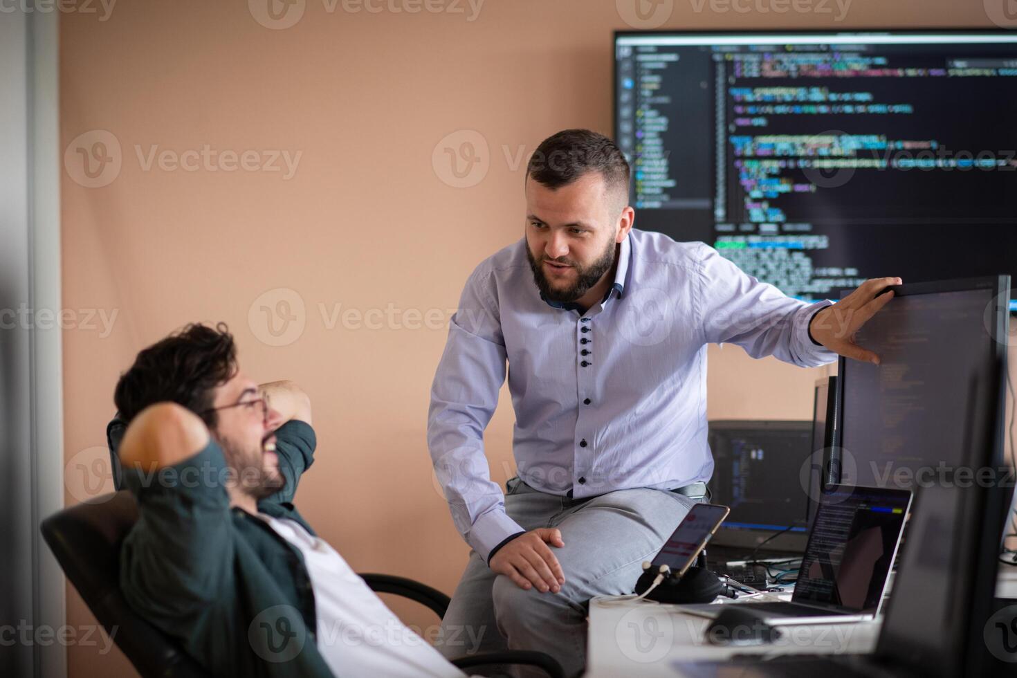Programmers engrossed in deep collaboration, diligently working together to solve complex problems photo