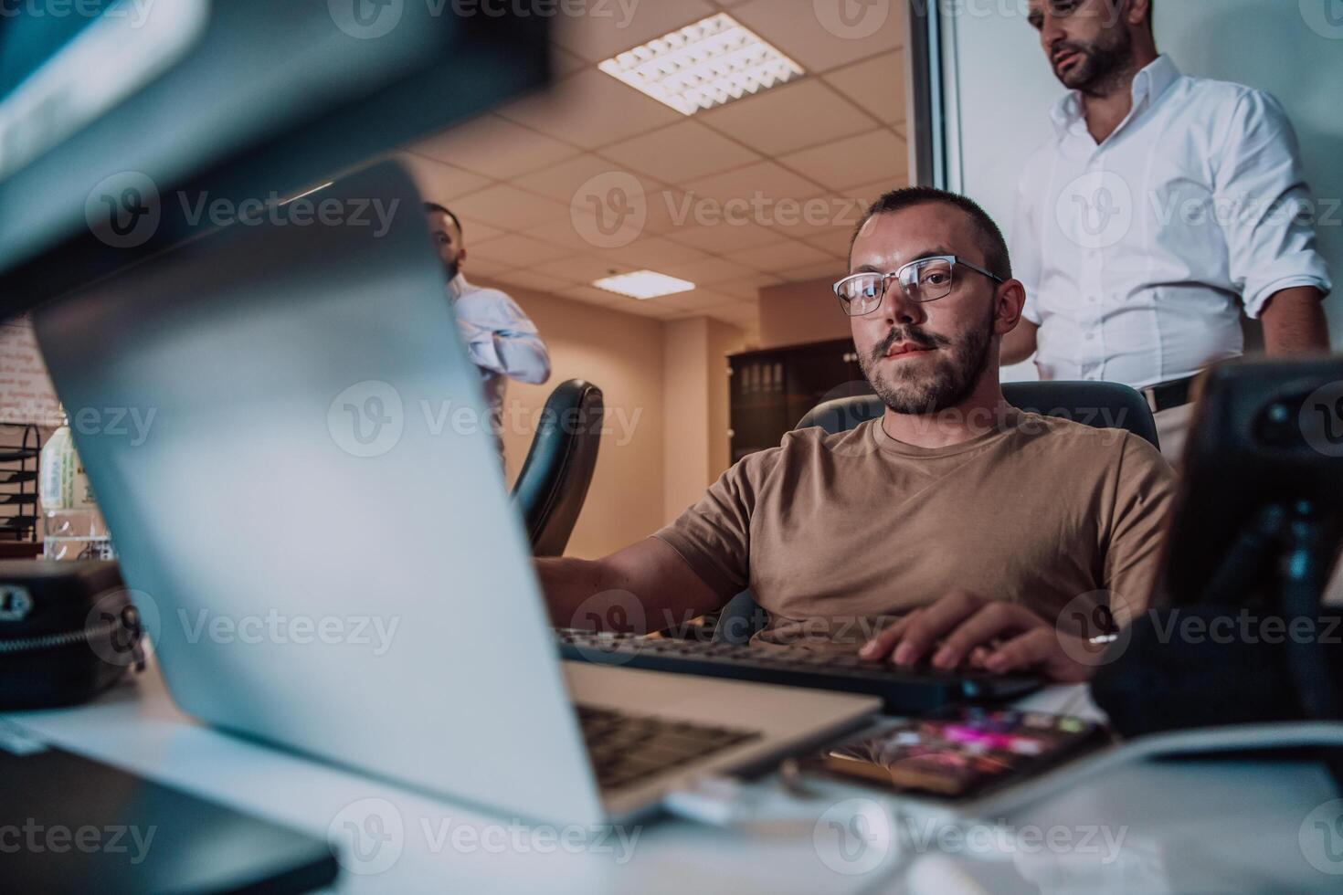 Programmers engrossed in deep collaboration, diligently working together to solve complex problems and develop innovative mobile applications with seamless functionality. photo