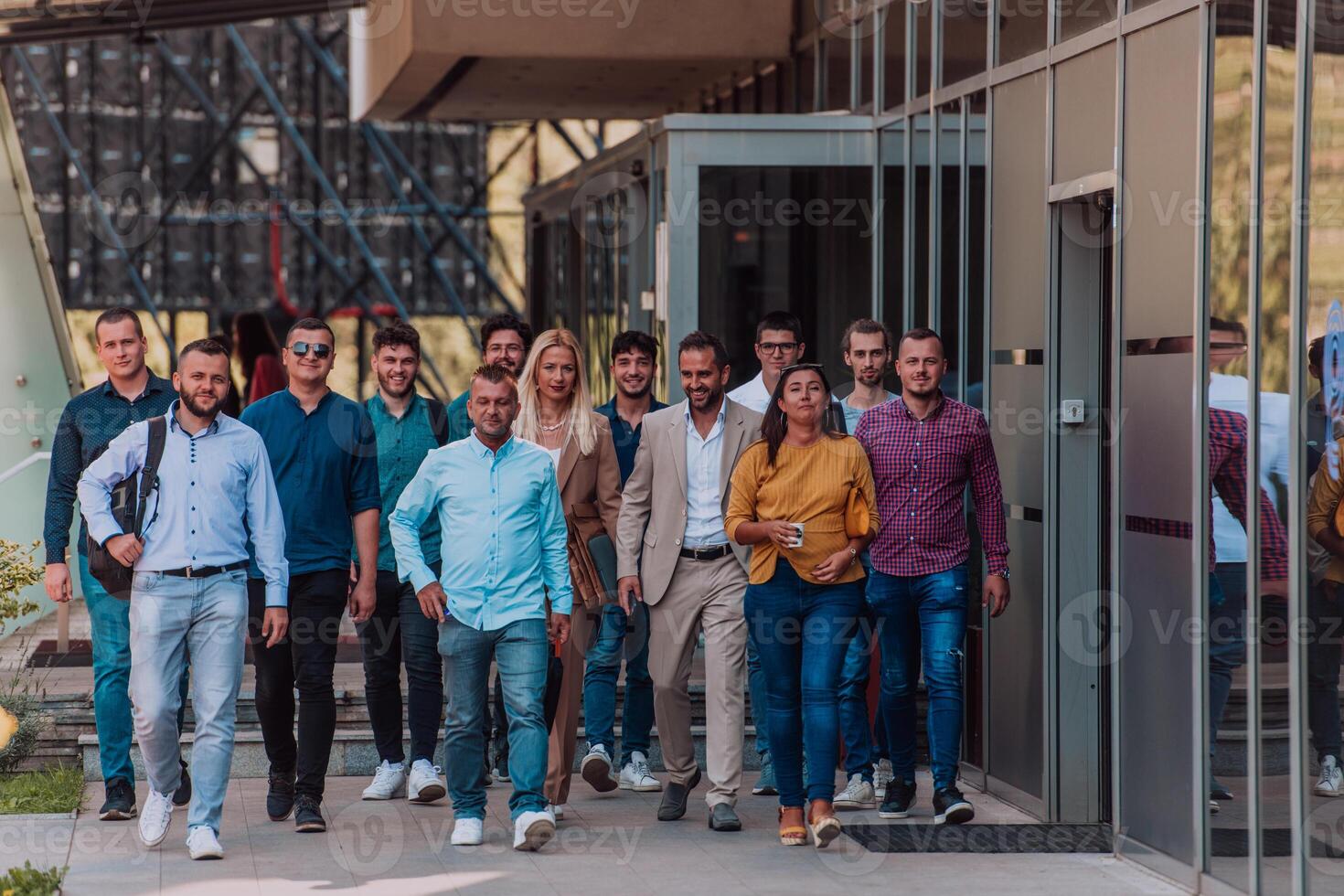 A diverse group of businessmen and colleagues walking together by their workplace, showcasing collaboration and teamwork in the company. photo