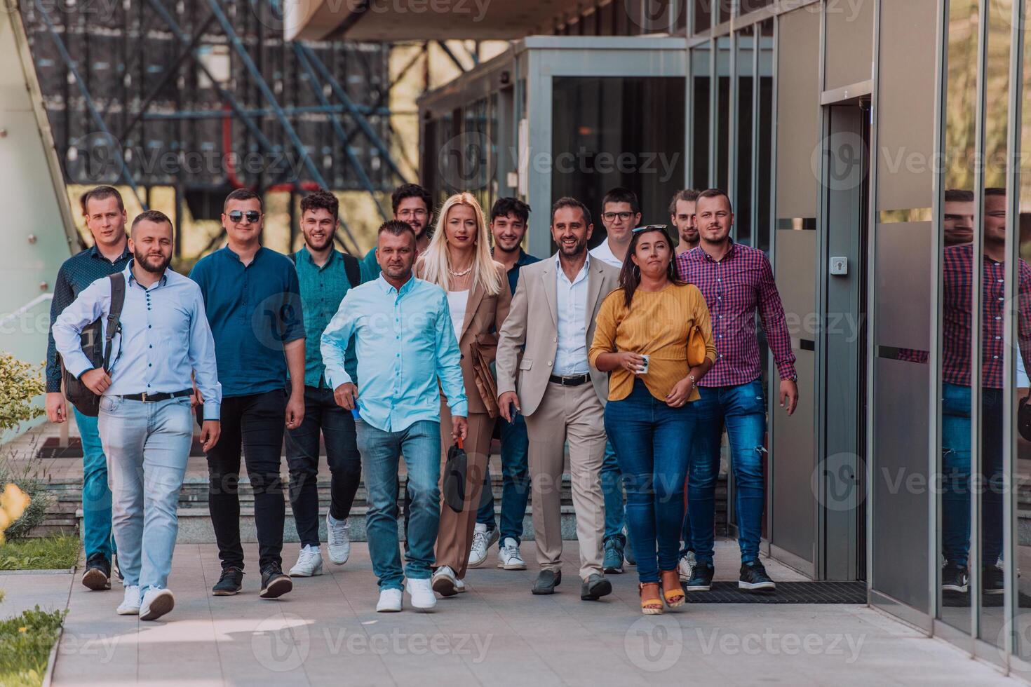 A diverse group of businessmen and colleagues walking together by their workplace, showcasing collaboration and teamwork in the company. photo