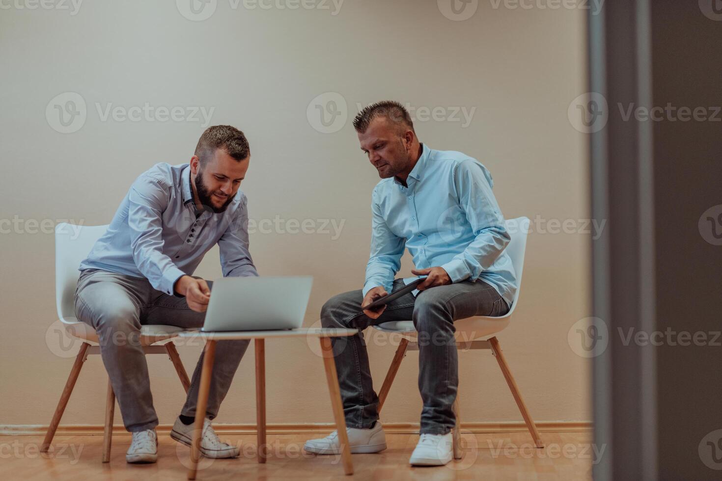 Programmers engrossed in deep collaboration, diligently working together to solve complex problems and develop innovative mobile applications with seamless functionality. photo