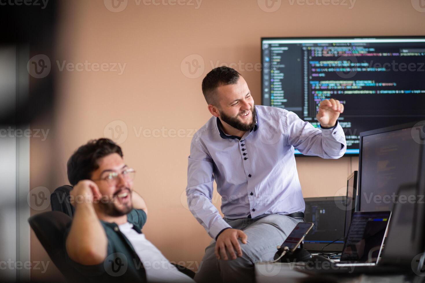 Programmers engrossed in deep collaboration, diligently working together to solve complex problems photo