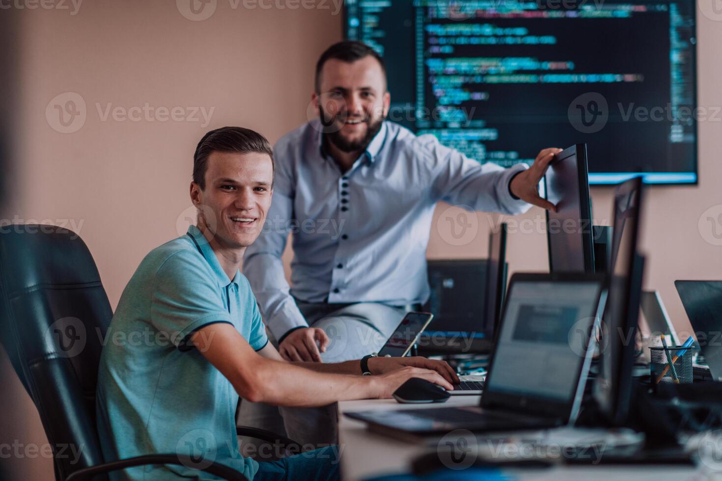 Programmers engrossed in deep collaboration, diligently working together to solve complex problems and develop innovative mobile applications with seamless functionality. photo