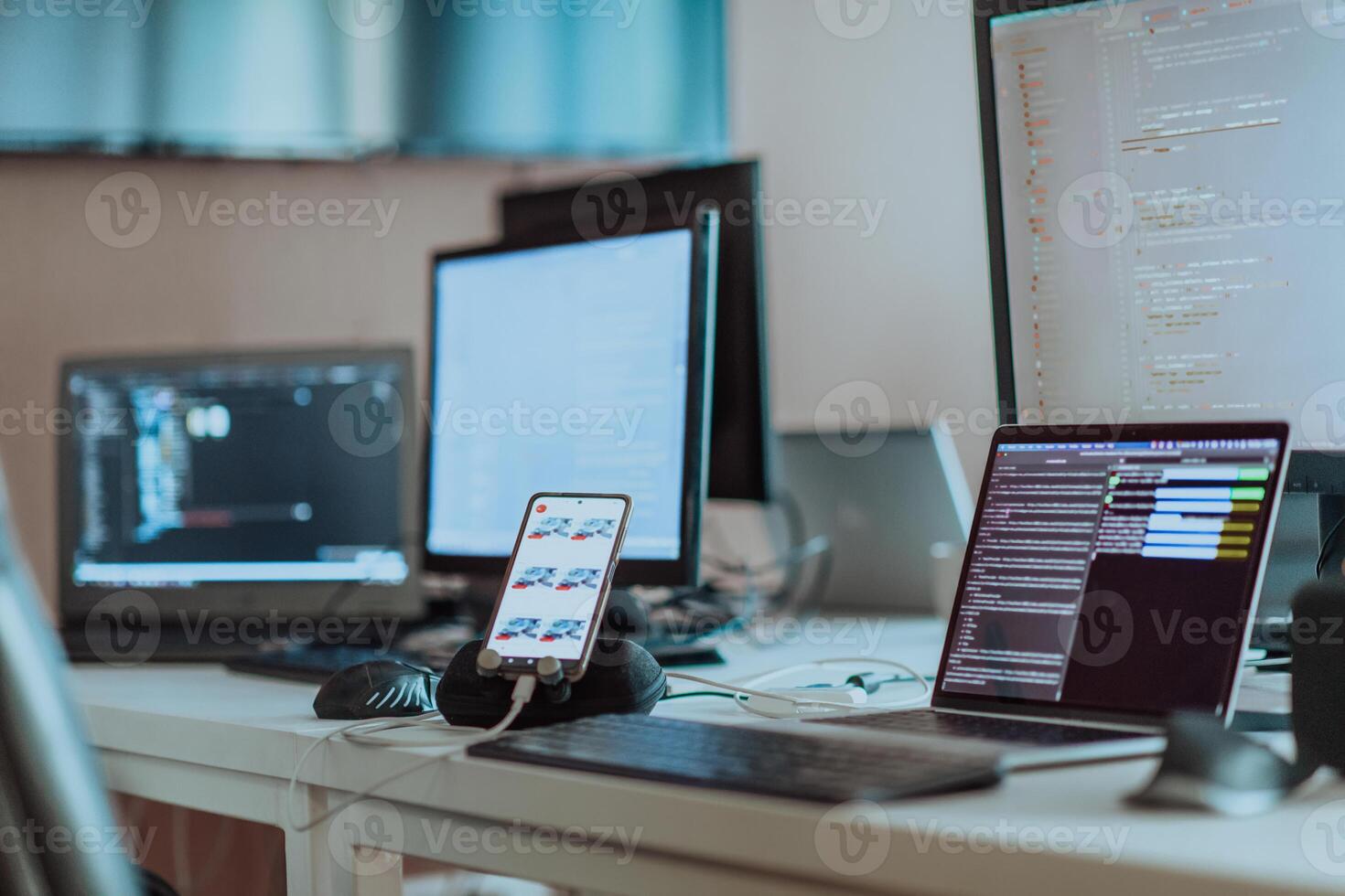 Computer screens running programming code in empty software developing agency office and computers parsing data algorithms in background. Neural network servers cloud computing in data room. photo