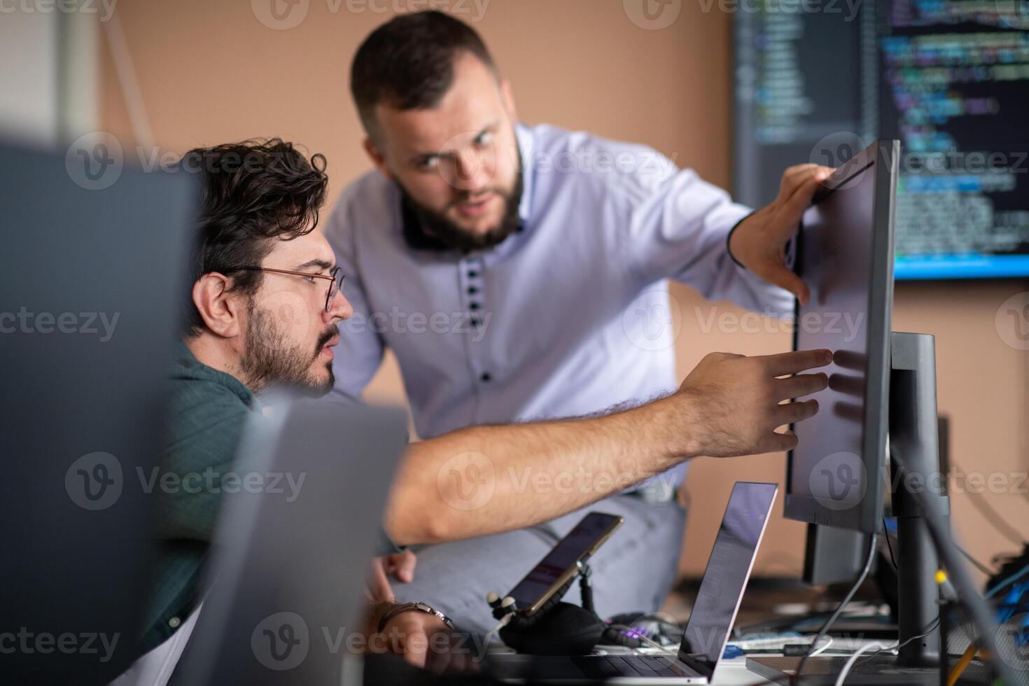 Programmers engrossed in deep collaboration, diligently working together to solve complex problems photo