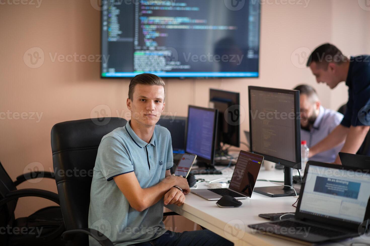 Innovating the Future. A Young Programmer Testing New Smartphone Apps in the Office. photo
