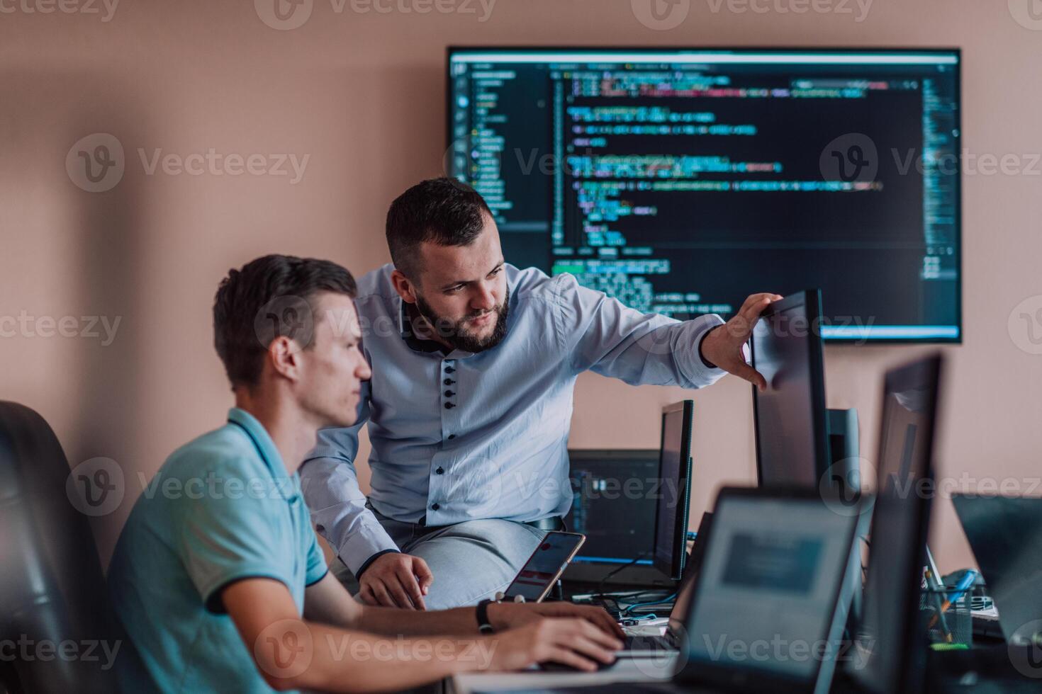 Programmers engrossed in deep collaboration, diligently working together to solve complex problems and develop innovative mobile applications with seamless functionality. photo