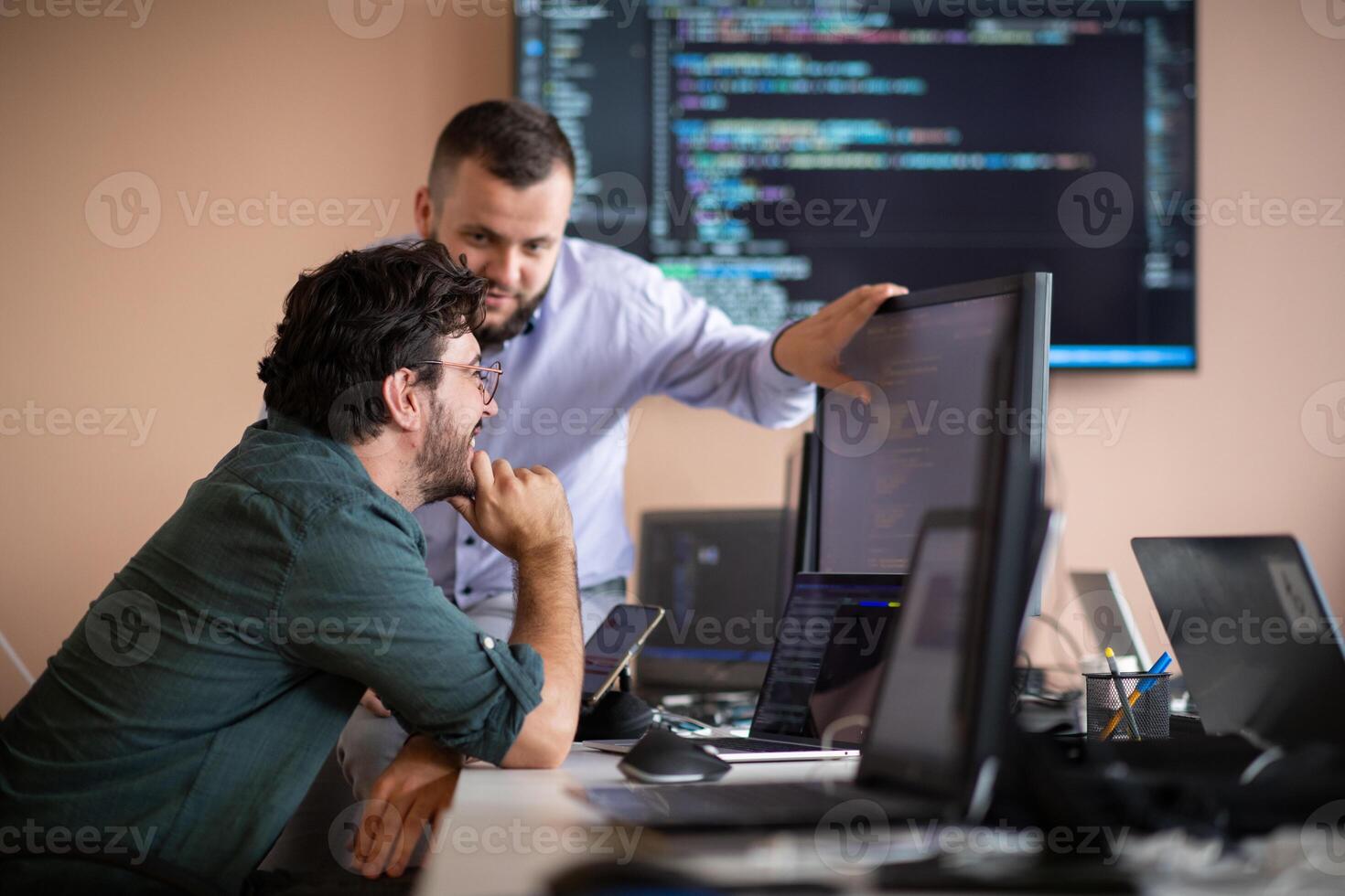 Programmers engrossed in deep collaboration, diligently working together to solve complex problems photo