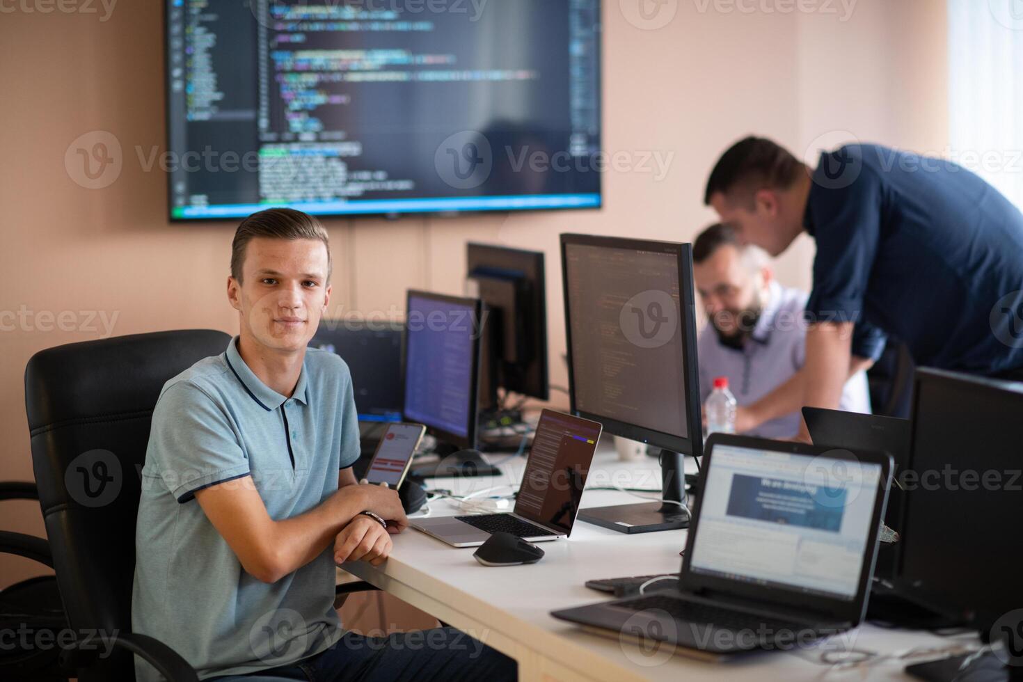 Innovating the Future. A Young Programmer Testing New Smartphone Apps in the Office. photo