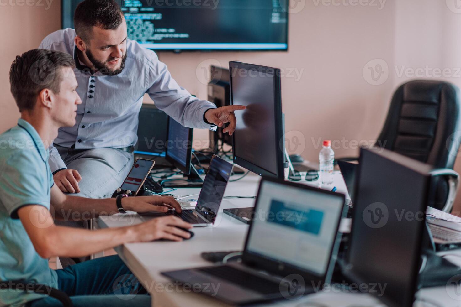Programmers engrossed in deep collaboration, diligently working together to solve complex problems and develop innovative mobile applications with seamless functionality. photo