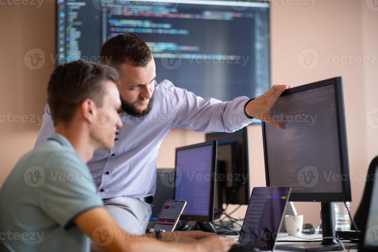 Programmers engrossed in deep collaboration, diligently working together to solve complex problems photo