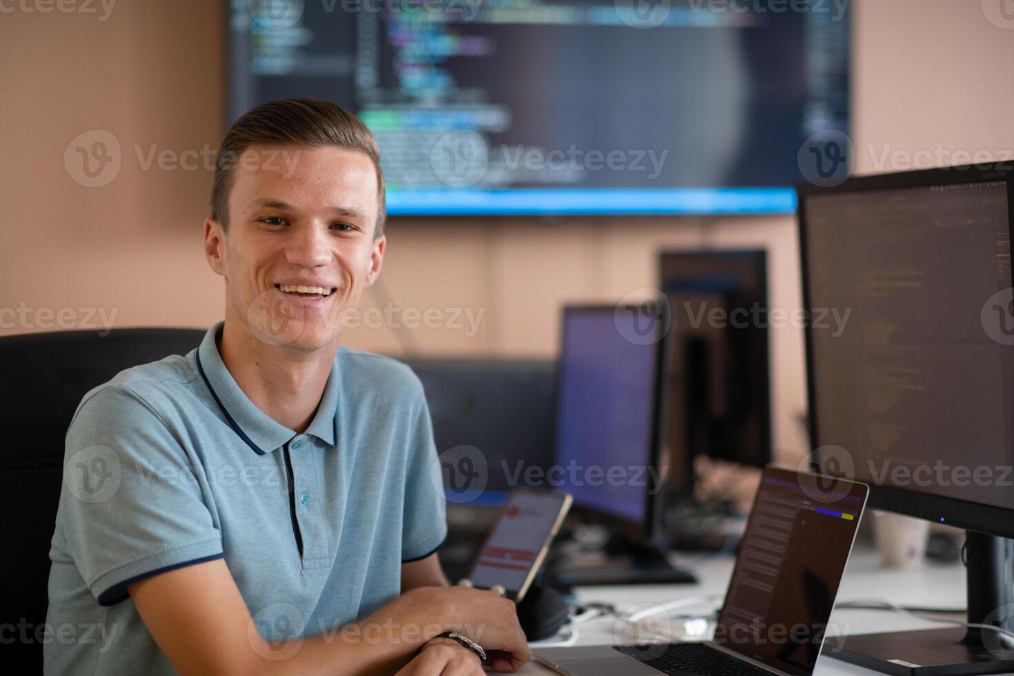 Innovating the Future. A Young Programmer Testing New Smartphone Apps in the Office. photo