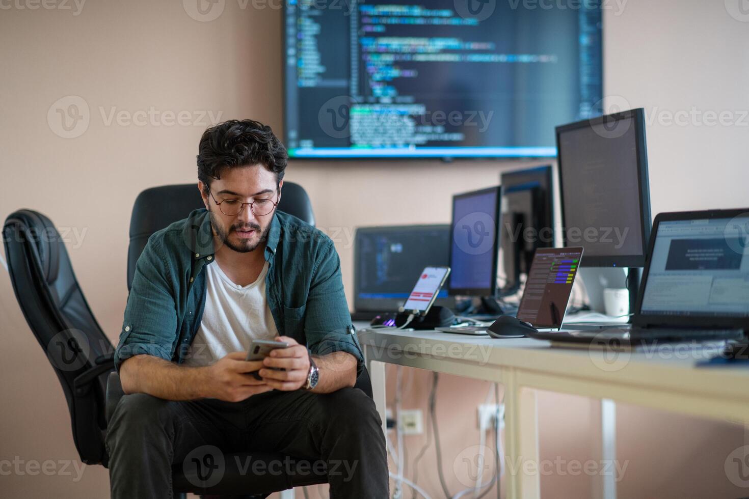 A programmer diligently testing smartphone applications photo