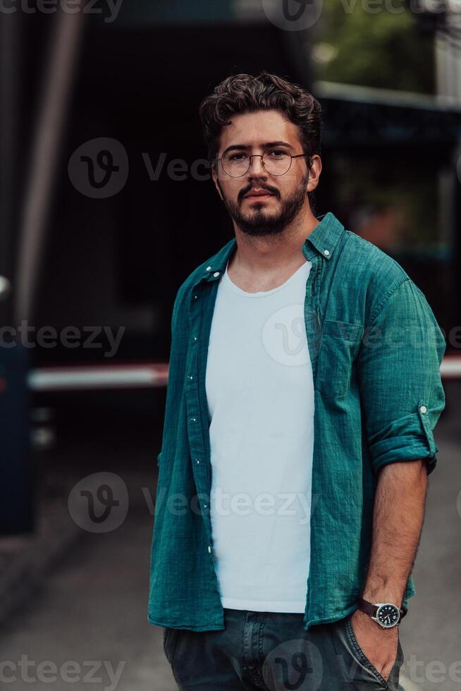 A portrait of a modern man, exuding confidence and style, against an outdoor backdrop, showcasing his charisma and fashionable demeanor. photo