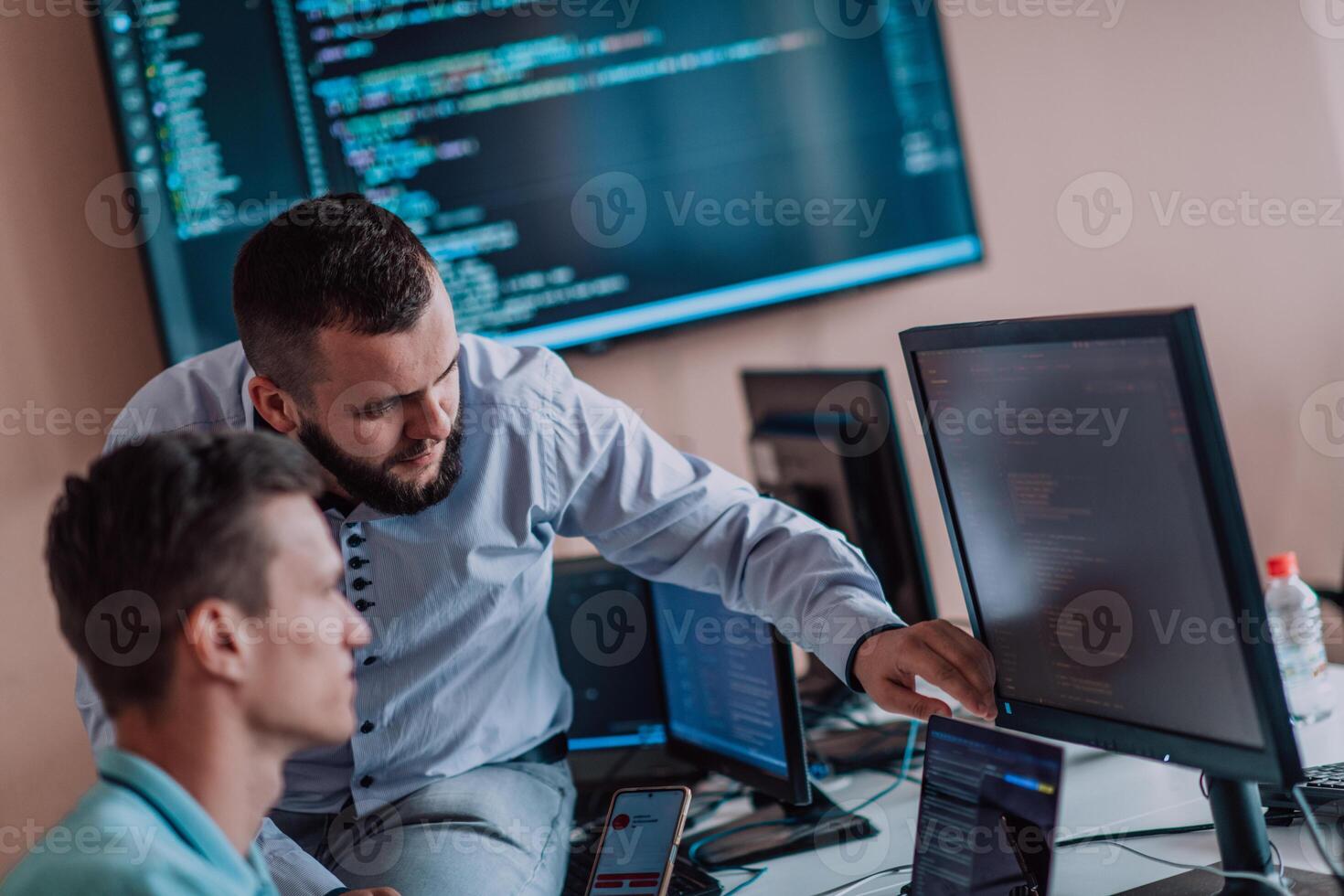 Programmers engrossed in deep collaboration, diligently working together to solve complex problems and develop innovative mobile applications with seamless functionality. photo