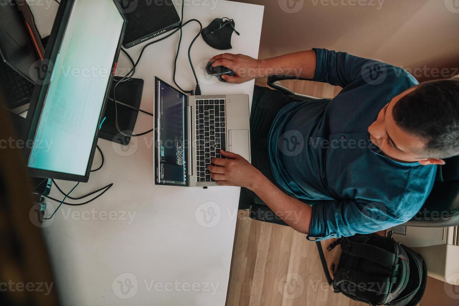 Top view of programmer diligently testing smartphone applications while sitting in their office. photo